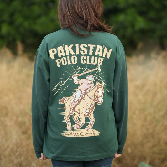 Person wearing a green 'Pakistan Polo Club' shirt with a horse and rider graphic outdoors.